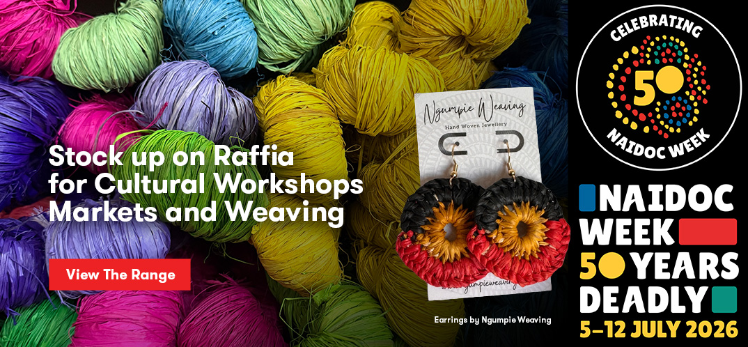 Raffia earrings by Ngumpie with raffia balls in the background